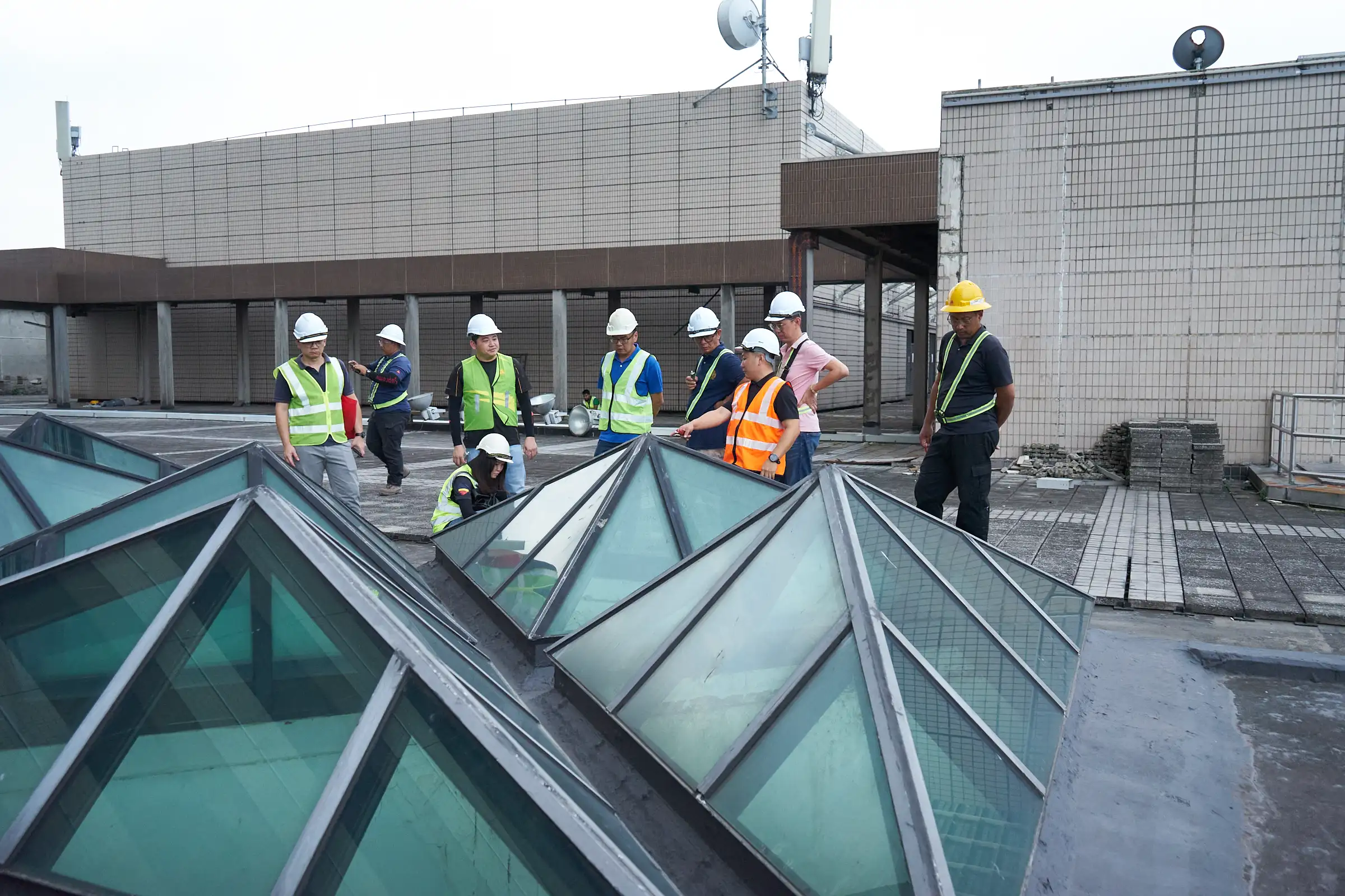 Technical and contractor teams reviewing waterproofing works on a Malaysian rooftop